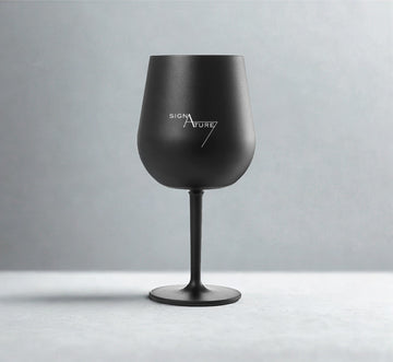 Black wine glass with 'Signature' logo on a gray background